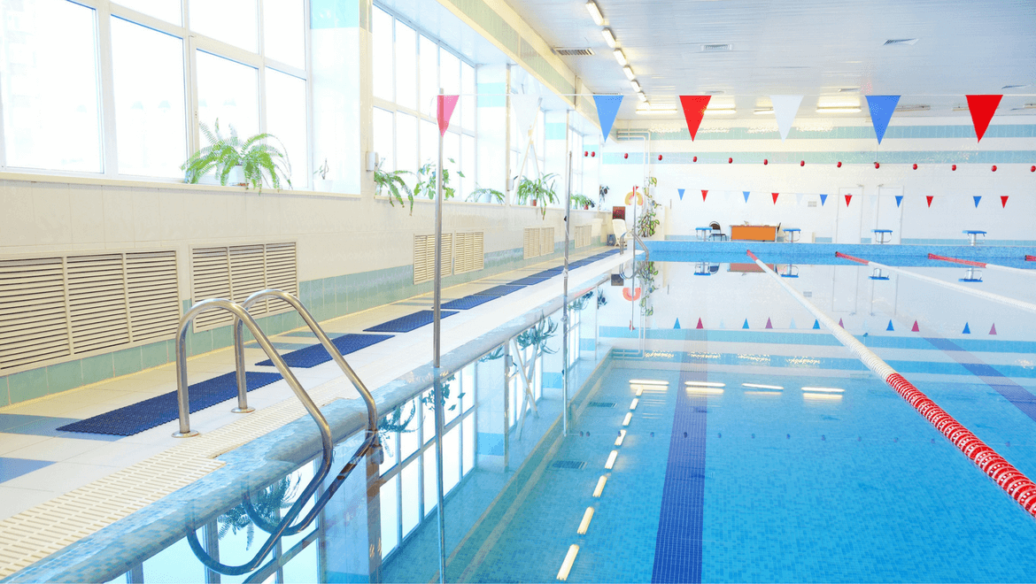 Indoor public swimming pool with bay window and lighting