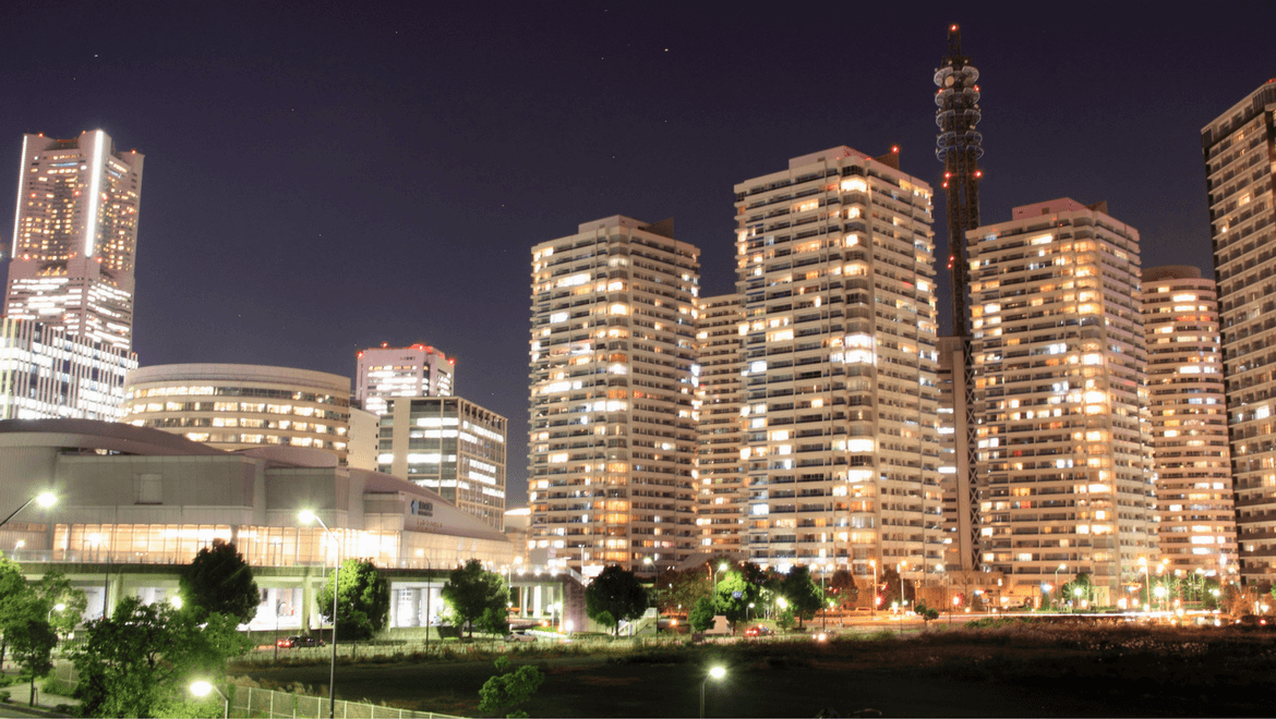 Buildings illuminated at night by outdoor lighting solutions