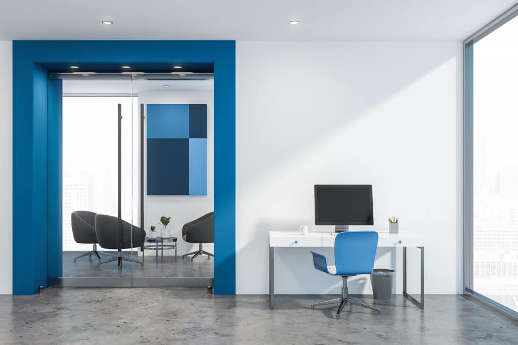 white and blue office with a computer and a desk lighted by the perfect downlights with the right features for this type of room